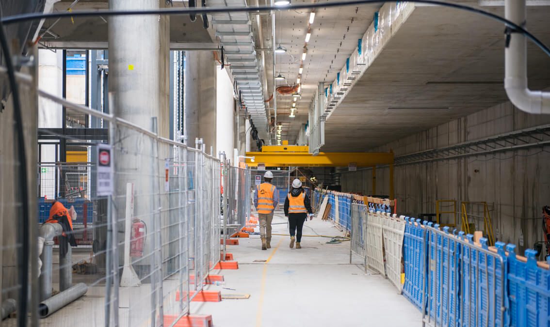 People walking in Arden station tunnel