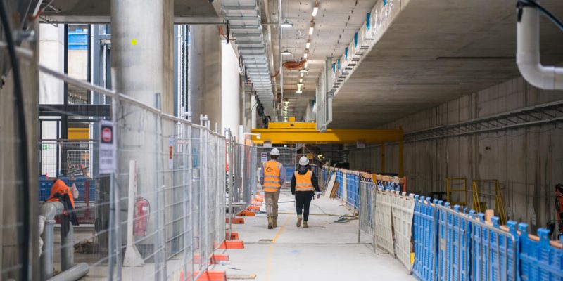 People walking in Arden station tunnel